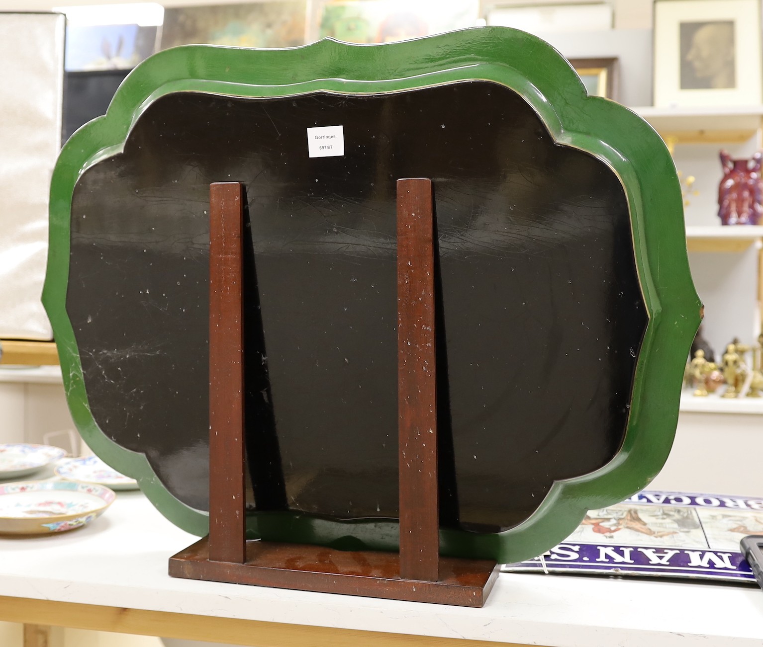 A green lacquered Papier mache tray with ornate gilding style decoration, with associated hardwood stand, 80cm wide